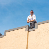 man on top of building