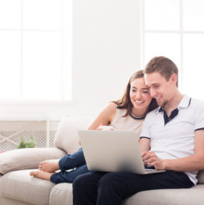 woman and man looking at laptop