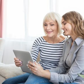 two women looking at an iPad